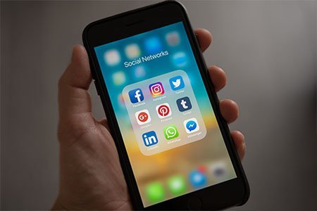 smart phone displaying social media icons on screen