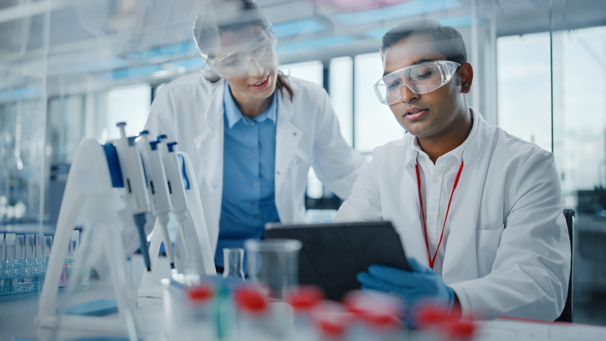 Two medical researchers examine results of their biotechnology marketing strategy