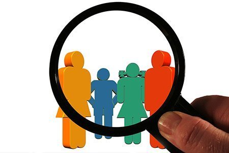 group of stick figures under magnifying glass