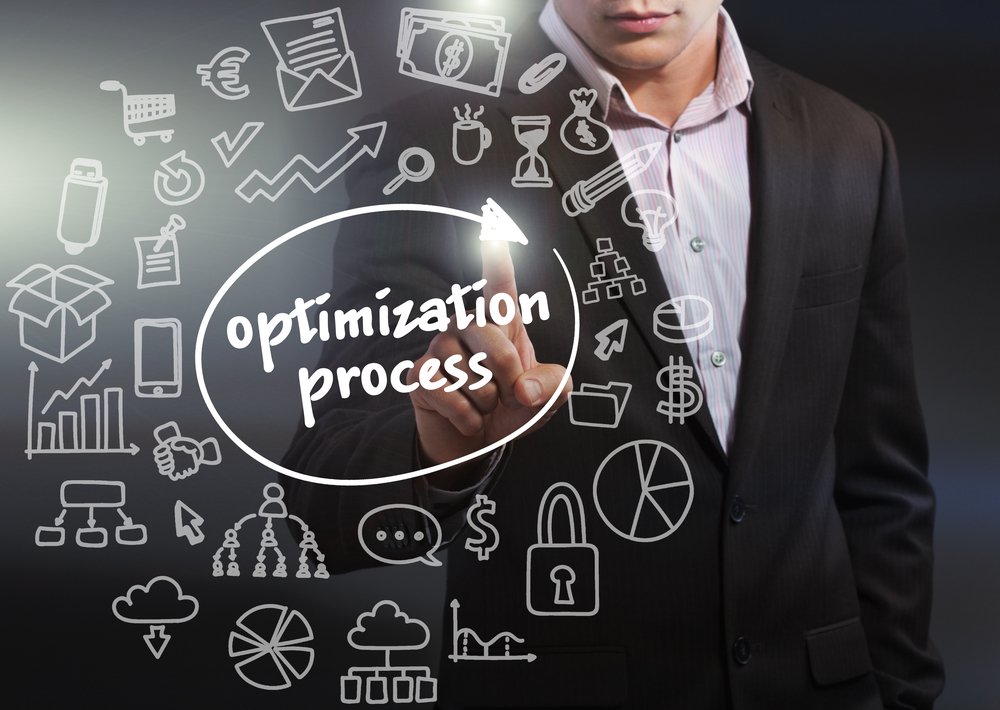 Business man pointing to optimization process text concept