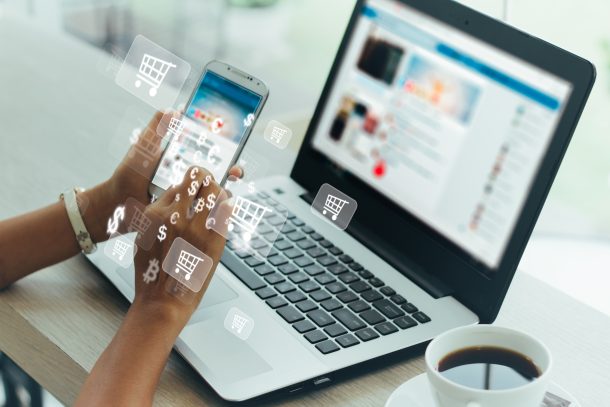 Person online shopping on laptop and phone