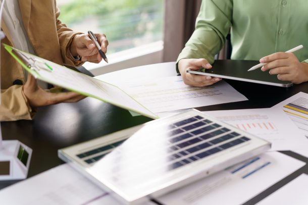 Two people sitting at table working on strategy