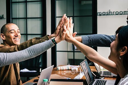 Office workers high five