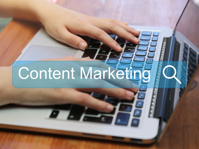 Hands on a laptop searching 'Content Marketing'
