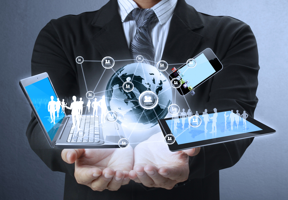 Man with laptop, tablet and mobile phone on top of his two hands with new technology concept icons